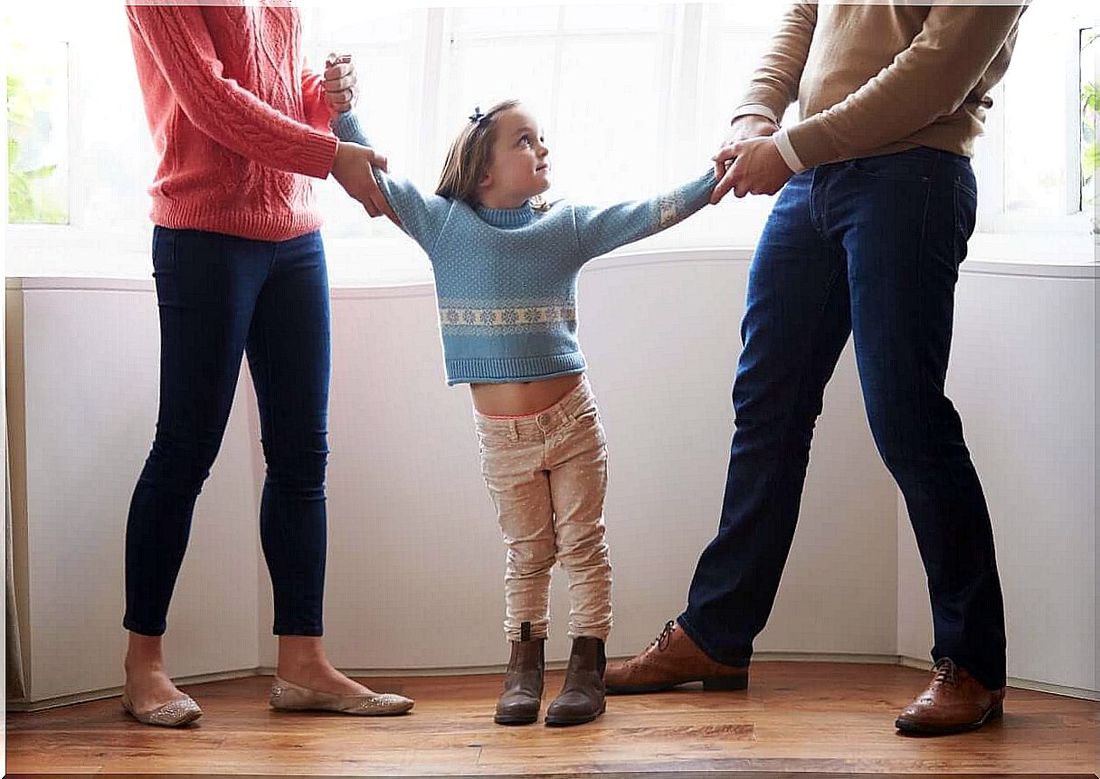 Child stands between the parents