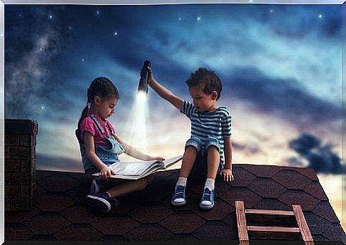 Children sitting on a roof reading