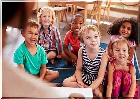 A group of children listens attentively