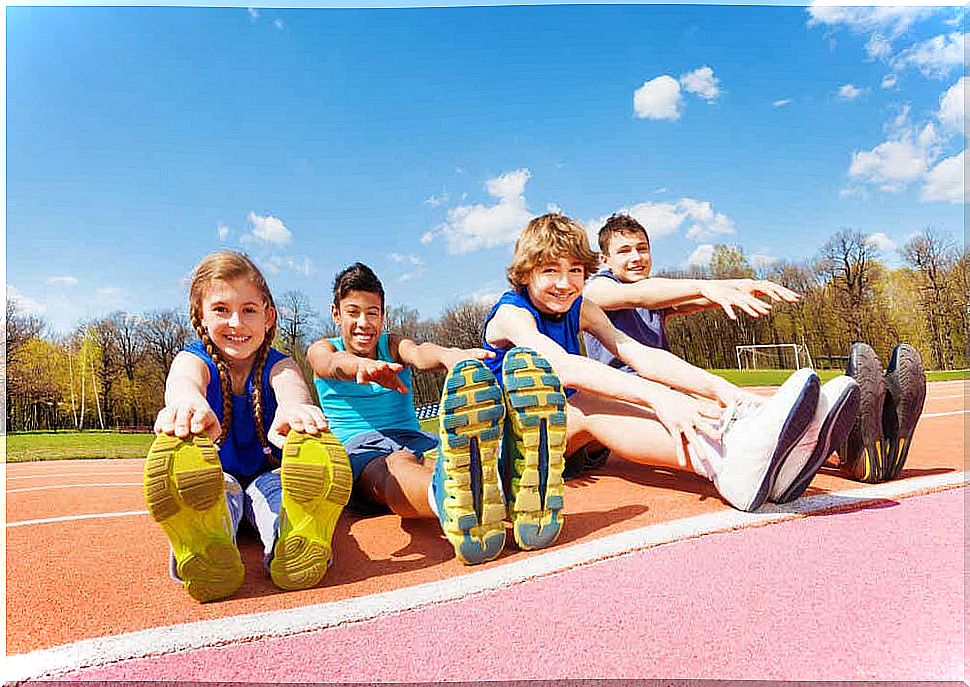 Children stretching on a track.