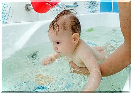 Baby gets clean water over his head