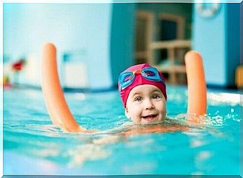 Baby in the pool with a float