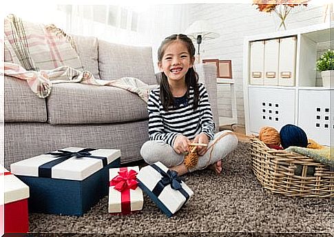 A girl is sitting among the presents