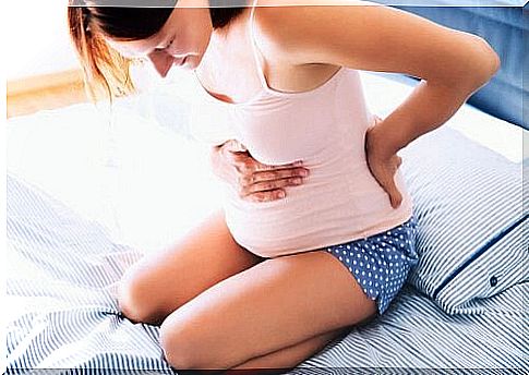 Pregnant woman with painful back and stomach