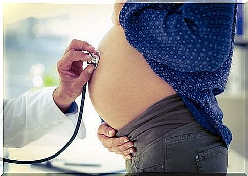 Doctor checks pregnant belly