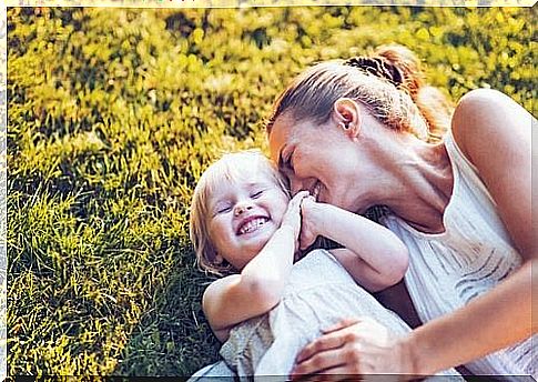 Mother and baby lying in the grass