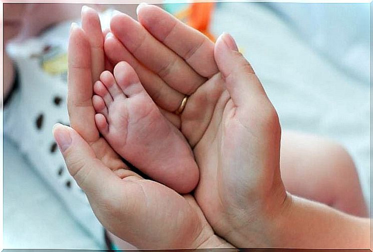 Mother holding her baby's foot