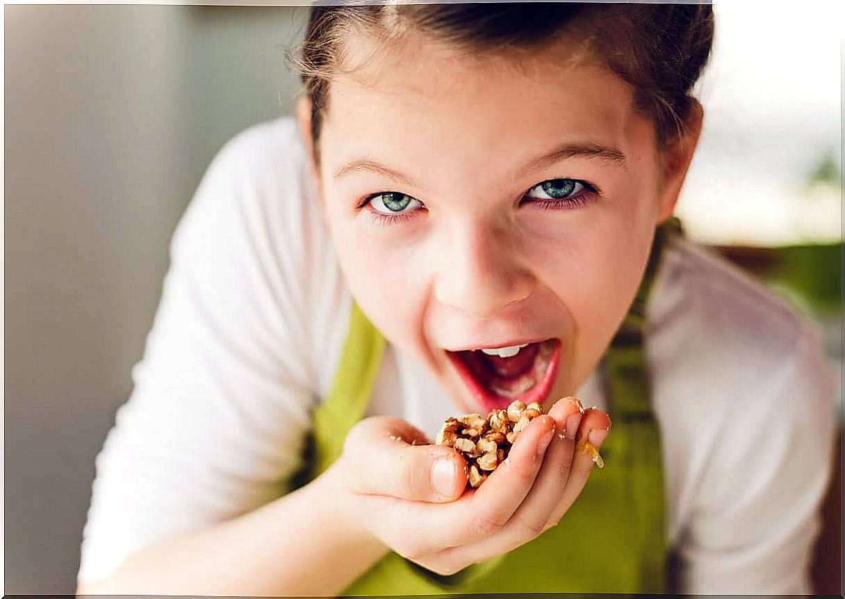 A child eats a handful of nuts