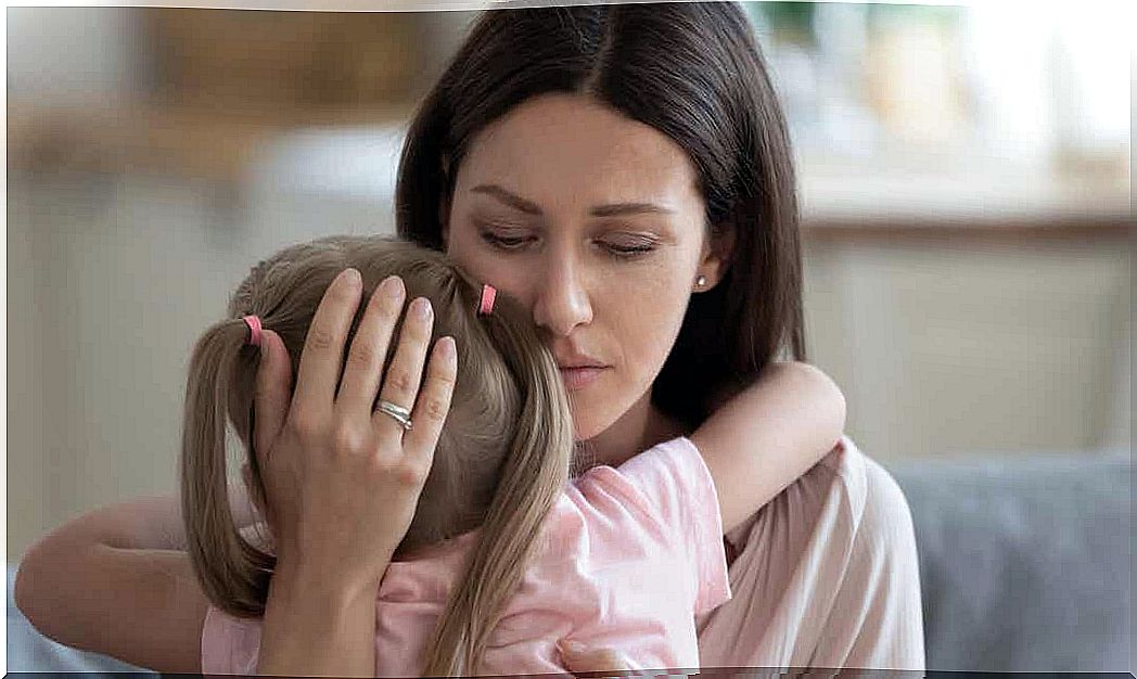 An unhappy mother hugging her little girl