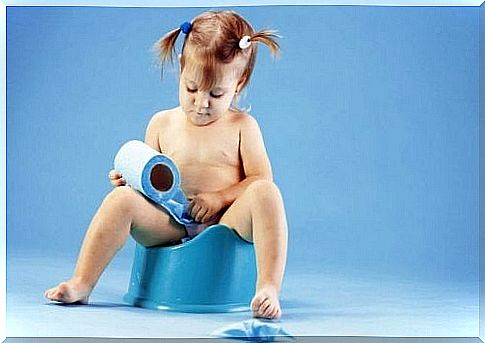 Girl sitting on a potty with a toilet roll