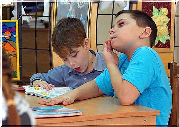 A child biting his nails in class.