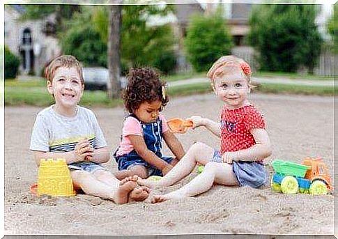 Children play together on the beach