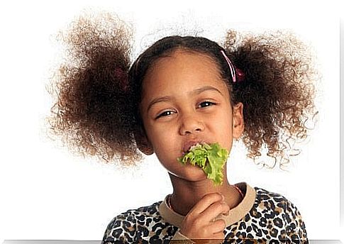 Girl with lettuce in her mouth