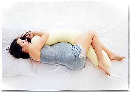 Pregnant woman kissing between legs