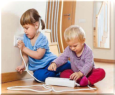 Toddlers playing with electrical outlets