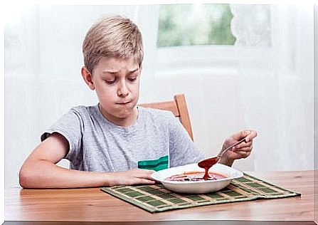 Child pulls long face at his food