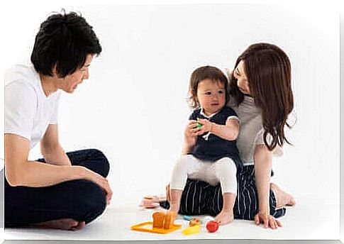 Parents play with their toddler